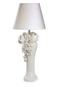 a white vase with a lamp and a lamp 