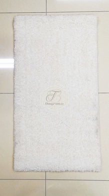 a white toilet sitting next to a white wall 