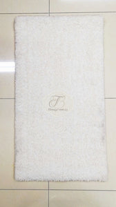 a white toilet sitting next to a white wall 